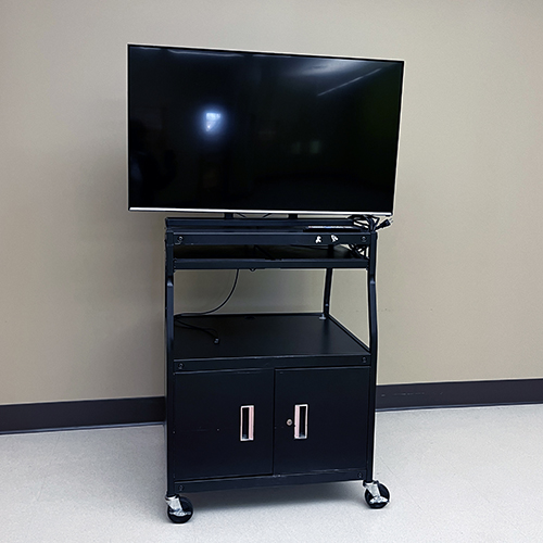 Large TV atop a rolling metal cart