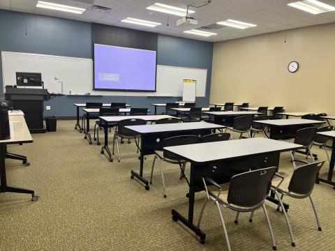 Classroom set up classroom style with projector screen in the front