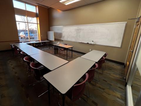 Classroom with tables and chairs in a horseshoe setup