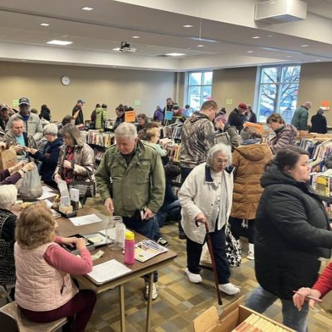 Room full of people browsing and buying books