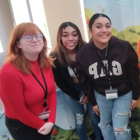 Three teen girls pose