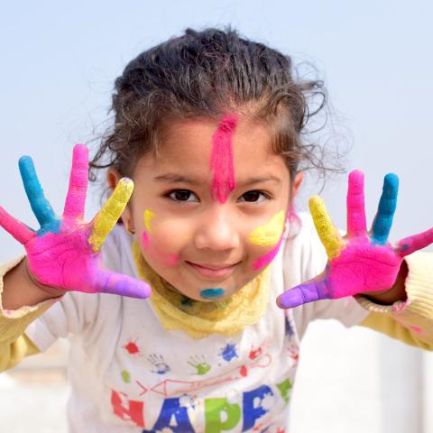 Girl with paint on her hands and face