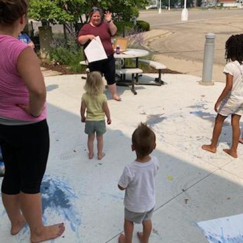 Kids on sidewalk with messy paint