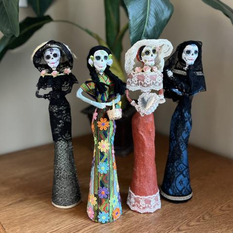 Four small hand-made Catrina dolls