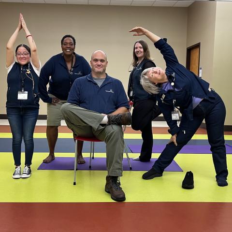 Staff members in various yoga poses