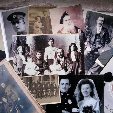 Old black and white photographs on a table