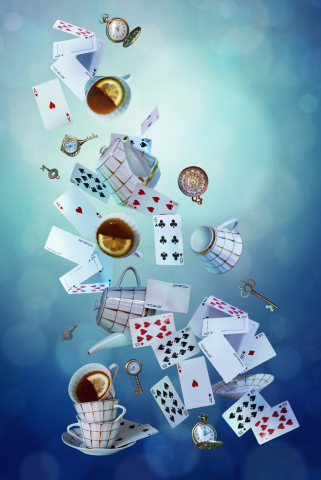 Tea cups, cards, and other Wonderland items in a swirl on a blue background