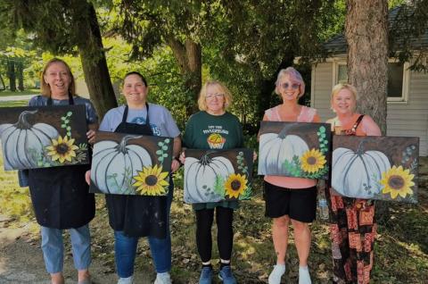 Art-Vark - 5 people holding artwork