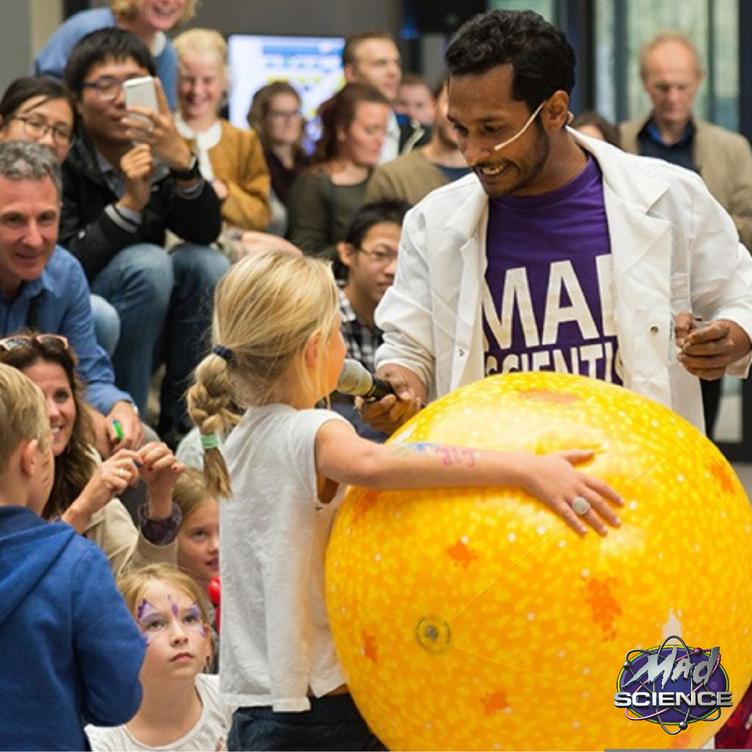 Scientist in front of a crowd of kids