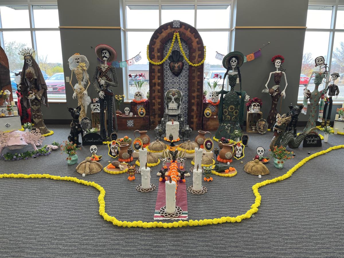A room full of handmade displays of catrinas and altars for Dia de los Muertos